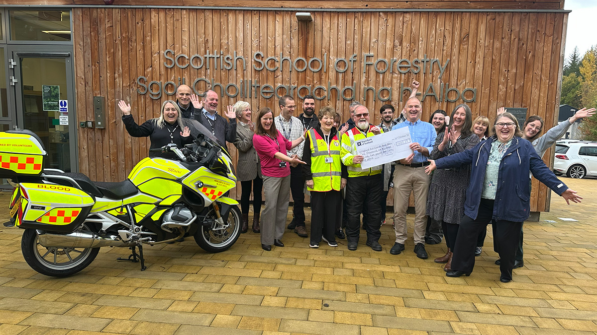 Big group of people holding a cheque and laughing Big group of people holding a cheque and laughing