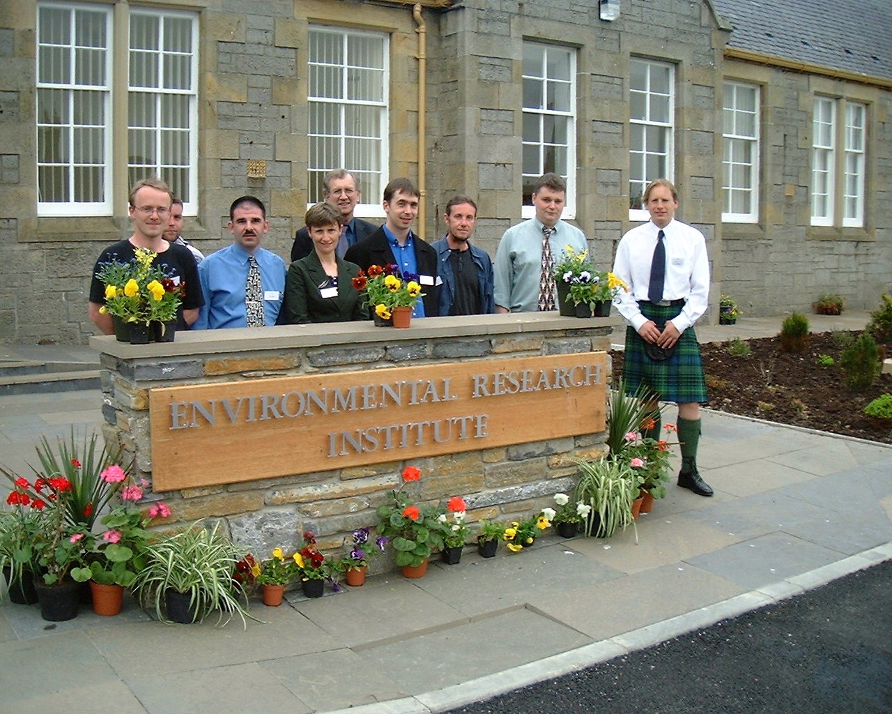 Group of people standing in front of the Environmental Research Institute sign Group of people standing in front of the Environmental Research Institute sign