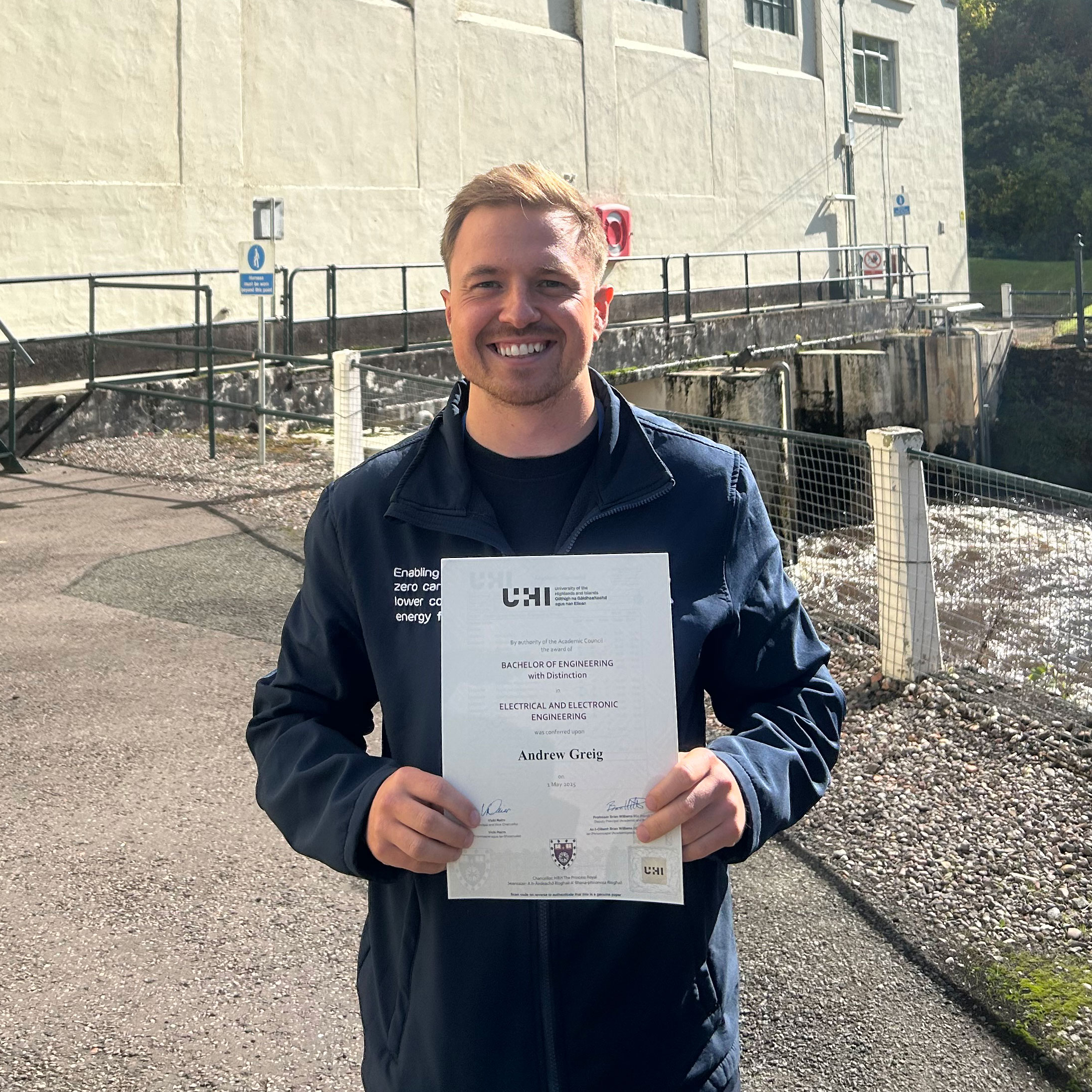 A student holding an award smiling