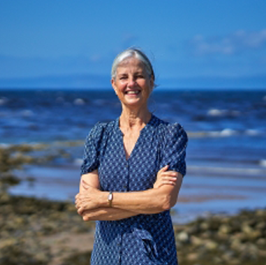 A student standing on the beach