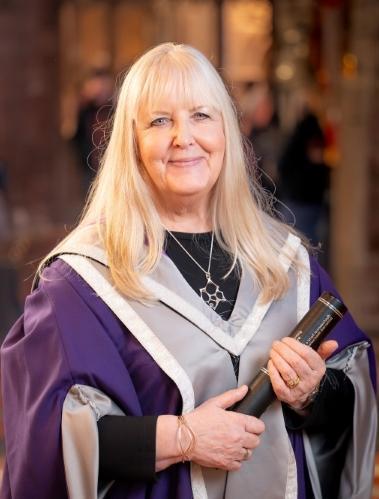 Sheila Fleet OBE, in gown holding certificate Sheila Fleet OBE, in gown holding certificate