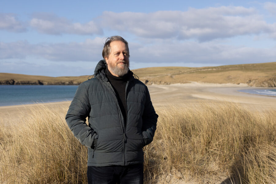 Photograph of Dr Andrew Jennings on a beach Photograph of Dr Andrew Jennings on a beach