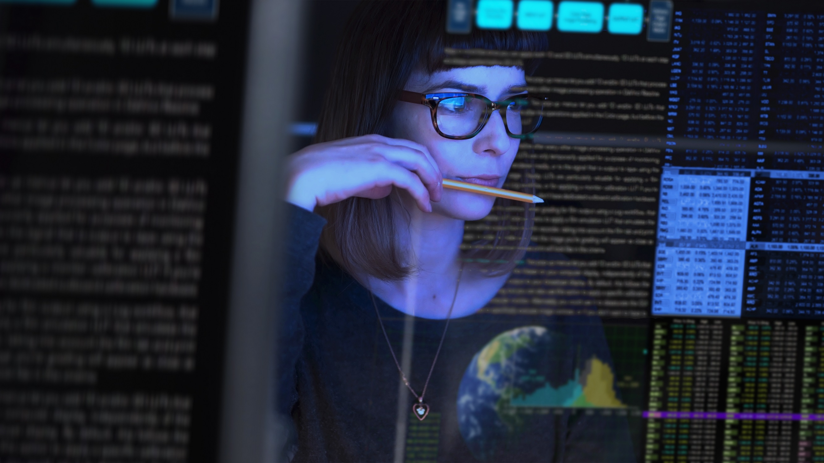Person looking at a computer with code superimposed on the image Person looking at a computer with code superimposed on the image