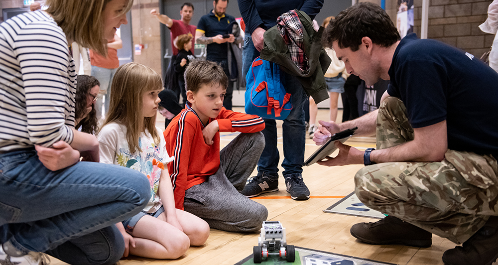 An adult explaining something on an Ipad to a child An adult explaining something on an Ipad to a child