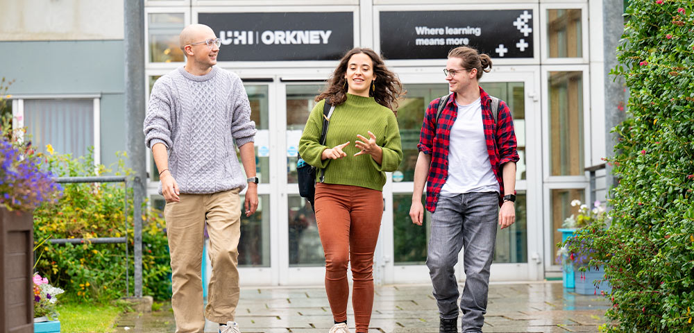 Three students walking outside UHI Orkney Three students walking outside UHI Orkney